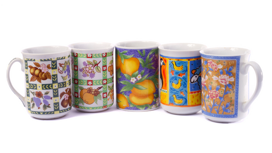 a group of four mugs with different designs on them