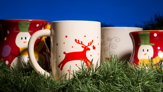 three coffee mugs with christmas designs on them