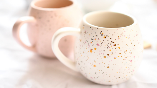 two coffee mugs with speckles on them