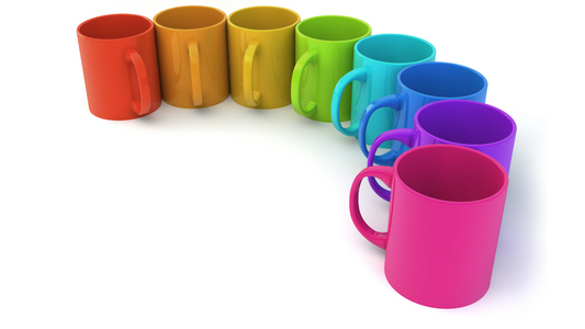 a row of colorful coffee mugs on a white background