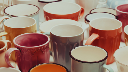 many different colored cups and mugs next to each other