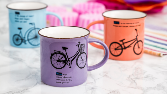 three colorful coffee mugs with bicycles on them