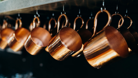 copper mugs hanging from the ceiling in a restaurant