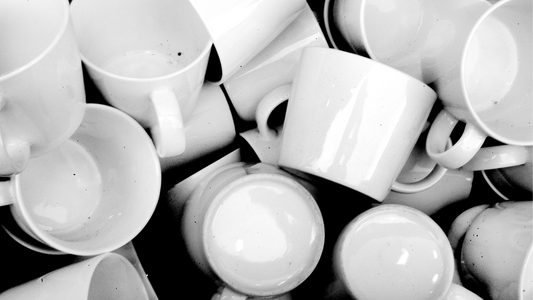 a black and white photo of many empty coffee cups