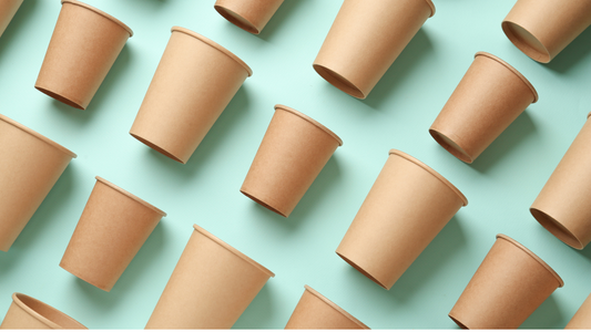 many brown paper cups arranged in a pattern on a blue background