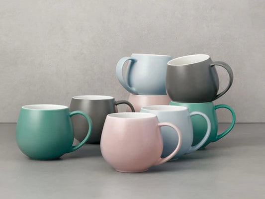 a stack of six mugs in different colors